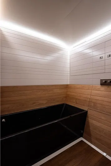 Canova Yacht Photos Pics Modern yacht bathroom with wood paneling and sleek black bathtub, Baltic Light Displacement Sailing Yacht 2019.