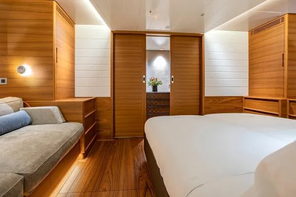 Canova Yacht Photos Pics Luxurious interior of 2019 Baltic Light Displacement Sailing Yacht with wooden finishes and cozy seating.