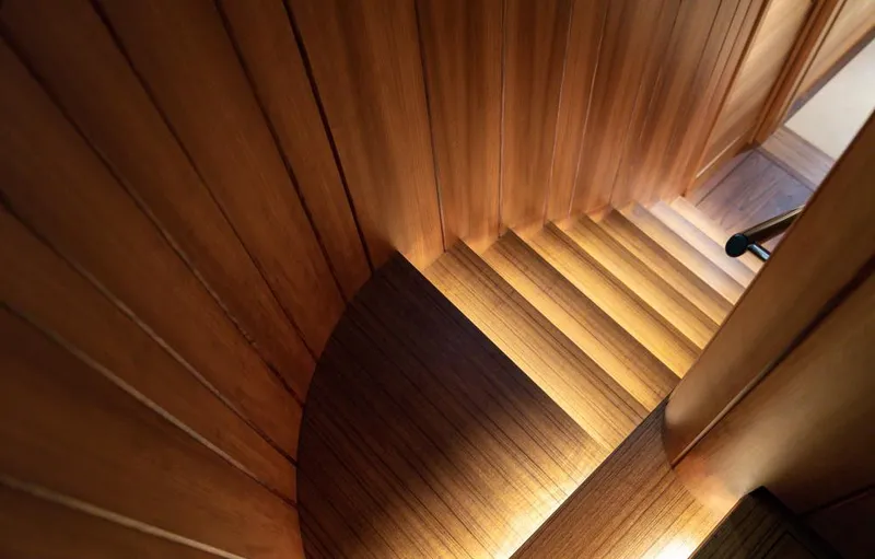 Canova Yacht Photos Pics Wooden staircase inside 2019 Baltic Light Displacement Sailing Yacht, featuring elegant lighting.