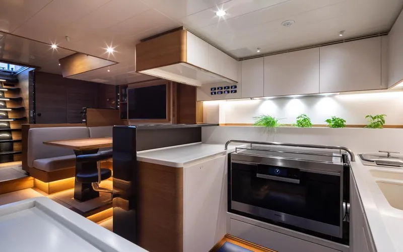 Canova Yacht Photos Pics Luxurious interior of 2019 Baltic Light Displacement Sailing Yacht with modern kitchen and dining area.