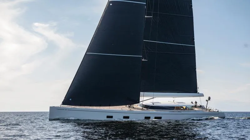 Canova Yacht Photos Pics Modern Baltic sailing yacht with sleek black sails on open water, 2019 model.