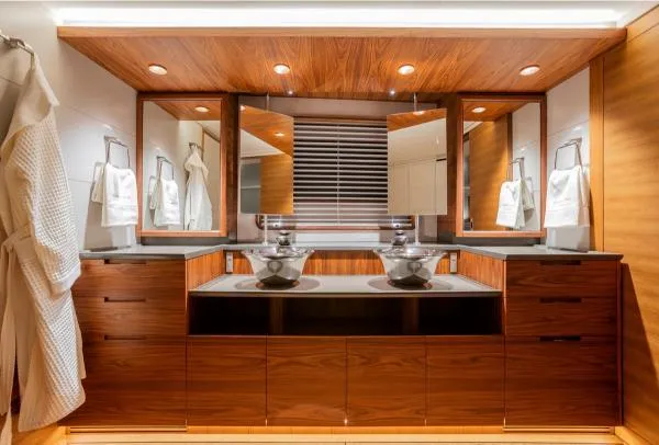Canova Yacht Photos Pics Luxurious yacht bathroom with wooden cabinetry, dual sinks, and modern lighting, Baltic 2019 model.