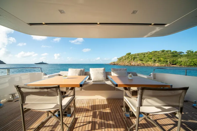 Squalo Yacht Photos Pics Luxury Sanlorenzo SL86 yacht deck with ocean view, featuring elegant seating and dining area, 2018 model.