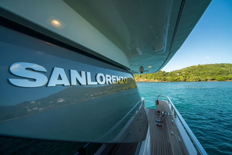 Squalo Yacht Photos Pics Sanlorenzo SL86 yacht, 2018 model, docked by scenic waters and lush greenery.