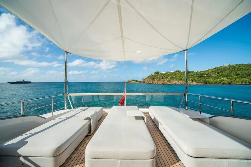 Squalo Yacht Photos Pics Luxurious 2018 Sanlorenzo SL86 yacht deck with sun loungers, ocean view, and canopy.