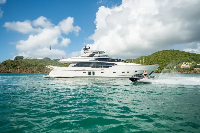 Squalo Yacht Photos Pics 2018 Sanlorenzo SL86 yacht cruising with jet ski nearby, under clear skies.