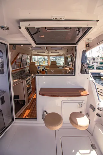 Arrow II Yacht Photos Pics 2019 Aspen C107 boat interior with seating and wooden accents.