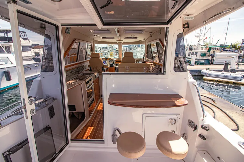 Arrow II Yacht Photos Pics Interior view of 2019 Aspen C107 boat with seating and kitchen area.