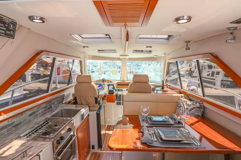 Arrow II Yacht Photos Pics Luxurious interior of 2019 Aspen C107 yacht with dining area and kitchen.