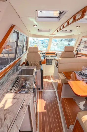 Arrow II Yacht Photos Pics Luxurious interior of 2019 Aspen C107 yacht with modern kitchen and seating area.