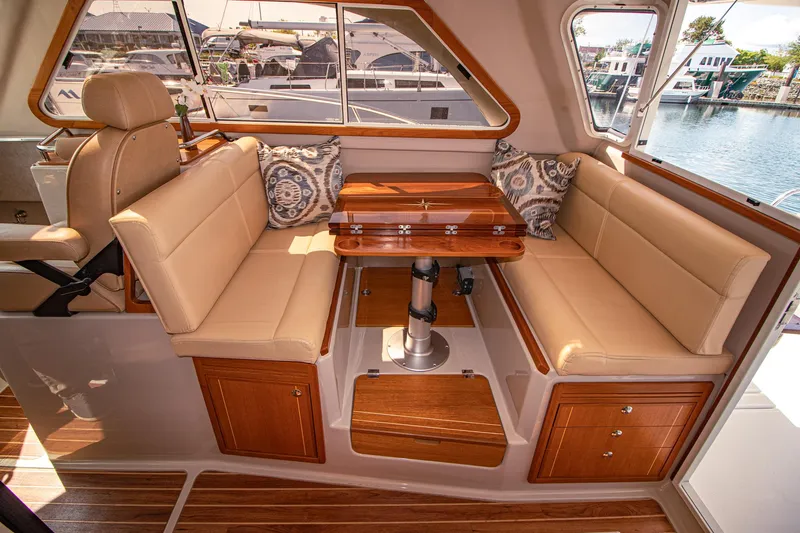 Arrow II Yacht Photos Pics Luxurious interior of 2019 Aspen C107 yacht with elegant seating and wooden table.