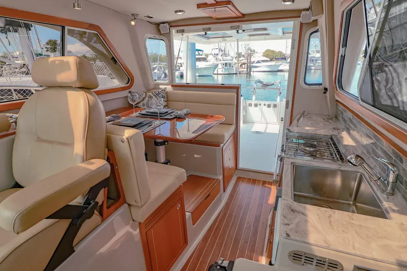 Arrow II Yacht Photos Pics Luxurious interior of 2019 Aspen C107 yacht with dining area and kitchenette.
