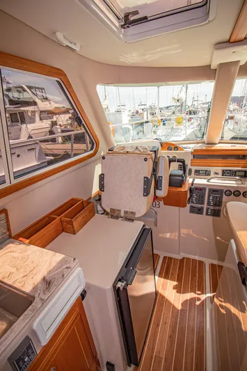 Arrow II Yacht Photos Pics Interior of 2019 Aspen C107 boat with wood accents and marina view.