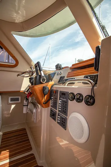 Arrow II Yacht Photos Pics 2019 Aspen C107 boat cockpit with control panel, steering wheel, and navigation equipment.