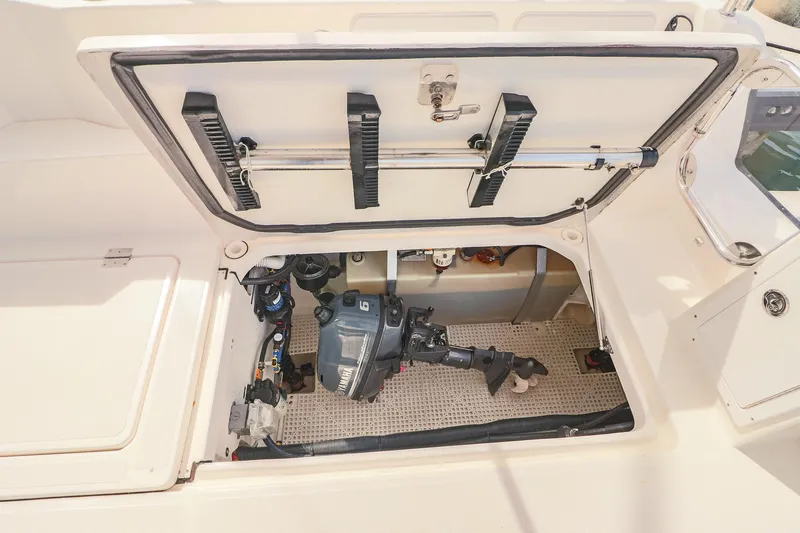 Arrow II Yacht Photos Pics Open engine compartment of 2019 Aspen C107 boat, showcasing internal components and storage.