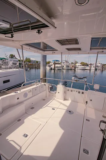 Arrow II Yacht Photos Pics Spacious deck of 2019 Aspen C107 boat, docked at a marina.