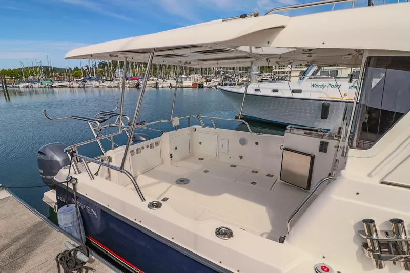 Arrow II Yacht Photos Pics 2019 Aspen C107 boat docked at marina, featuring spacious deck and modern design.