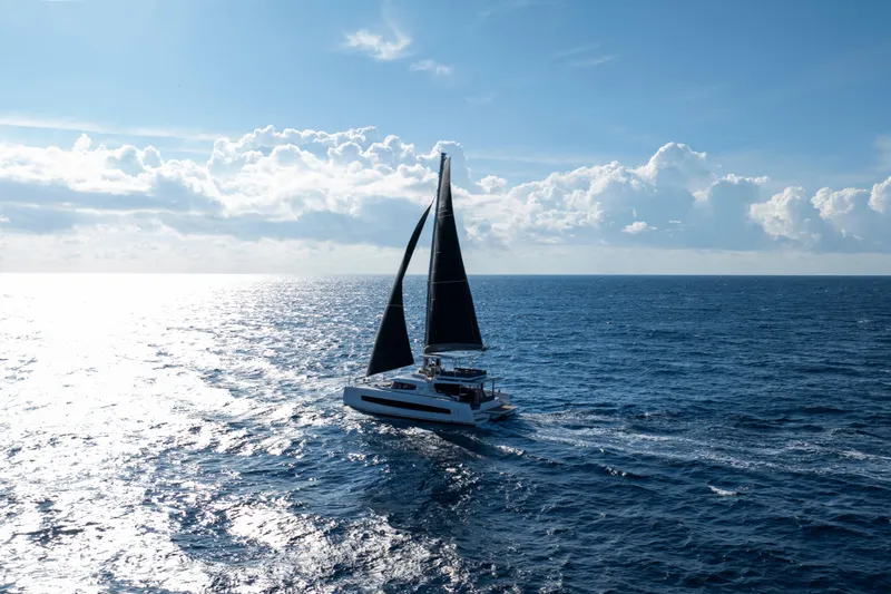  Yacht Photos Pics Sailing catamaran Bali 5.2 (2026) on open ocean under clear blue sky.