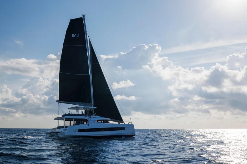  Yacht Photos Pics Sailing catamaran Bali 5.2, 2026 model, cruising under cloudy sky.
