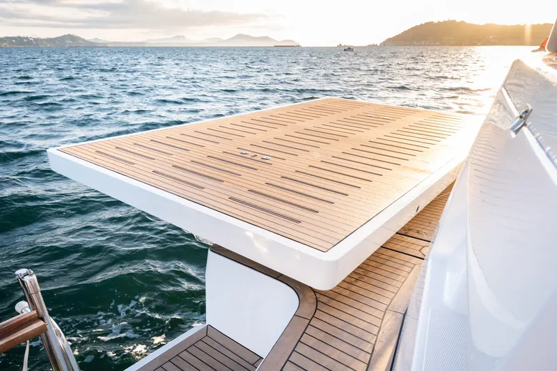  Yacht Photos Pics Luxurious Bali 5.2 yacht deck overlooking serene ocean at sunset, 2026 model.