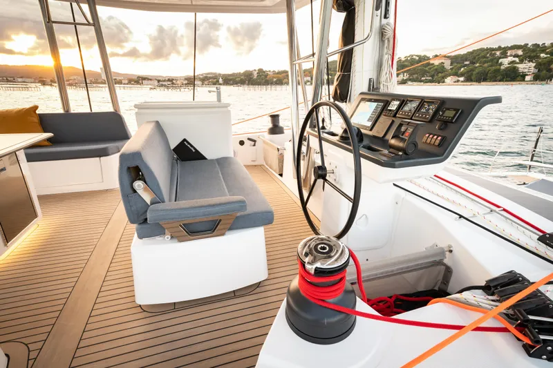  Yacht Photos Pics Modern Bali 5.2 yacht cockpit with sleek design, advanced controls, and scenic ocean view at sunset.