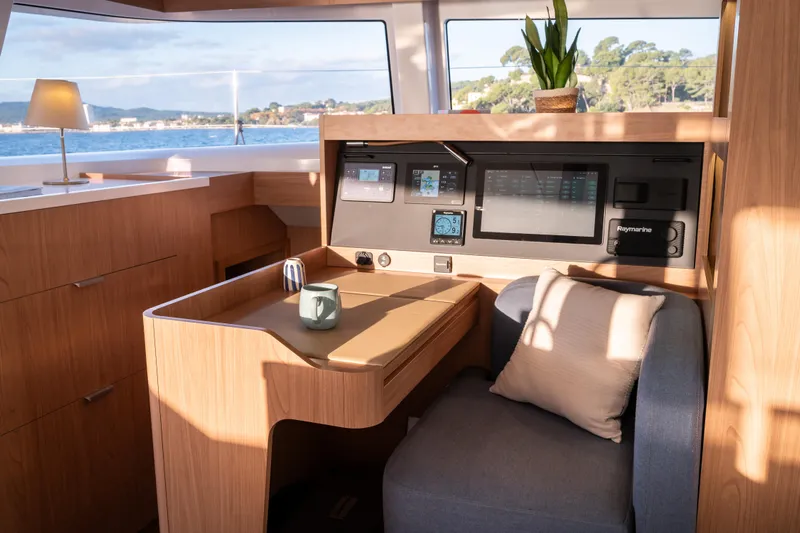  Yacht Photos Pics Modern interior of 2026 Bali 5.2 yacht with navigation station and cozy seating.