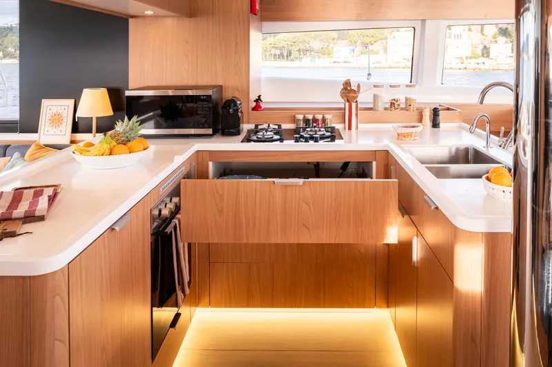  Yacht Photos Pics Modern kitchen interior on Bali 5.2 yacht, 2026 model, featuring wood cabinetry and sleek appliances.