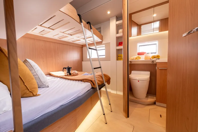  Yacht Photos Pics Luxurious interior of 2026 Bali 5.2 yacht cabin with cozy bed and modern bathroom.