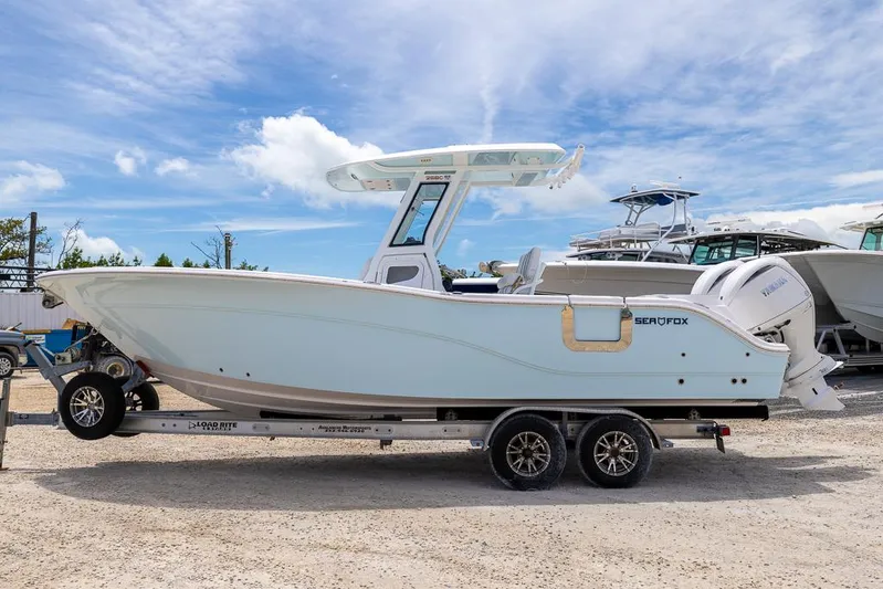  Yacht Photos Pics 2026 Sea Fox 268 Commander boat on trailer under blue sky.