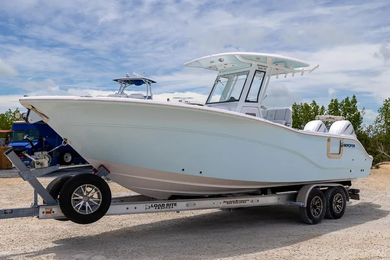  Yacht Photos Pics 2026 Sea Fox 268 Commander boat on trailer under a cloudy sky.