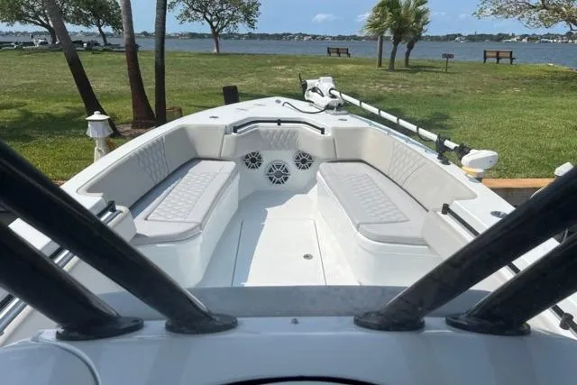  Yacht Photos Pics 2023 Contender 32 ST boat interior with seating, docked by a scenic lake.