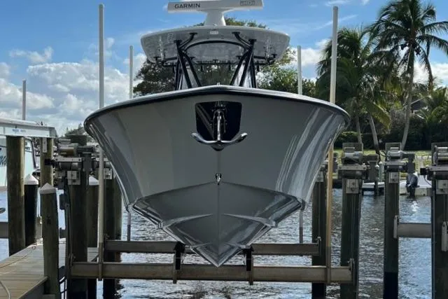  Yacht Photos Pics 2023 Contender 32 ST boat docked, front view with palm trees in background.