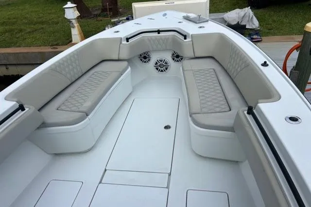  Yacht Photos Pics 2023 Contender 32 ST boat interior with cushioned seating and modern design.