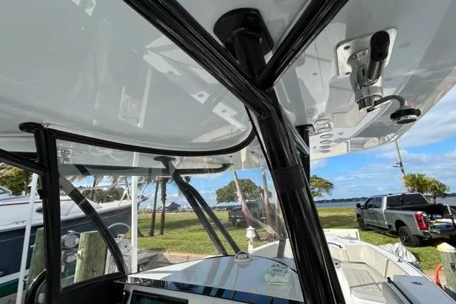  Yacht Photos Pics 2023 Contender 32 ST boat interior with sleek design and modern features, docked near a scenic waterfront.