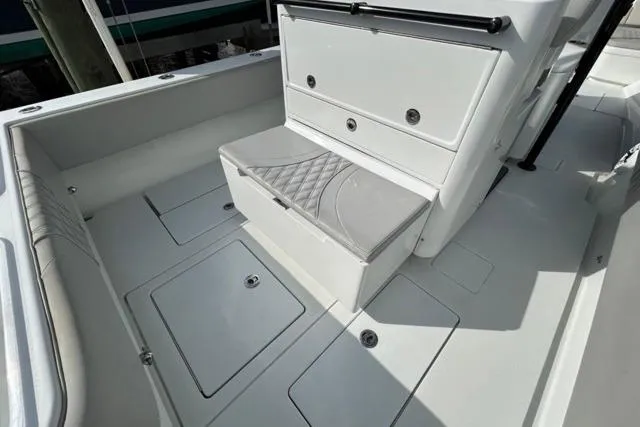  Yacht Photos Pics 2023 Contender 32 ST boat interior with cushioned seating and storage compartments.