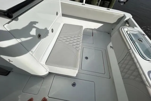  Yacht Photos Pics 2023 Contender 32 ST boat interior with cushioned seating and storage compartments.