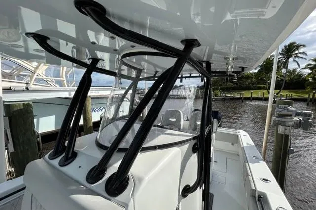  Yacht Photos Pics 2023 Contender 32 ST boat docked, featuring sleek design and sturdy construction.