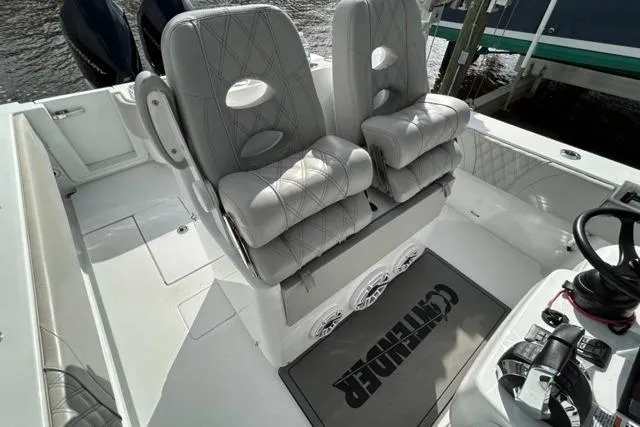  Yacht Photos Pics 2023 Contender 32 ST boat interior with cushioned seats and steering console.