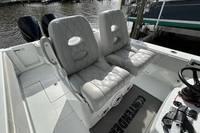  Yacht Photos Pics 2023 Contender 32 ST boat interior with dual cushioned seats and steering wheel.