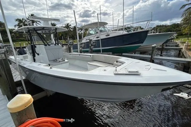  Yacht Photos Pics 2023 Contender 32 ST boat docked, sleek design, ready for adventure.