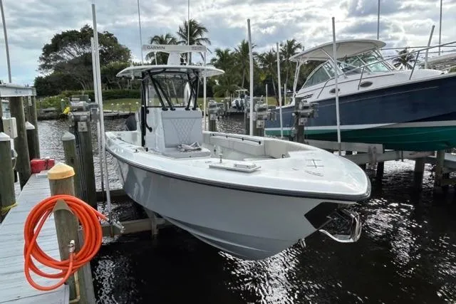  Yacht Photos Pics 2023 Contender 32 ST boat docked at marina with palm trees in background.
