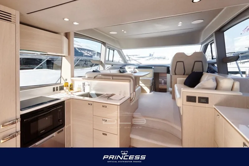  Yacht Photos Pics Luxurious interior of 2023 Princess F50 yacht with modern kitchen and seating area.