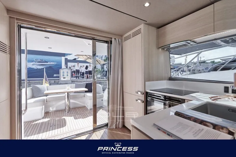 Yacht Photos Pics Luxurious interior of 2023 Princess F50 yacht with modern kitchen and outdoor seating.