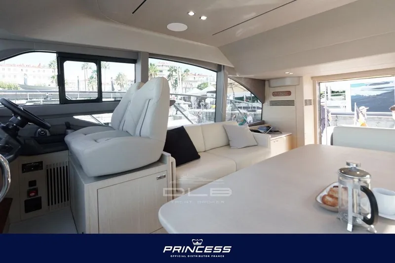  Yacht Photos Pics Luxurious interior of 2023 Princess F50 yacht with modern seating and dining area.