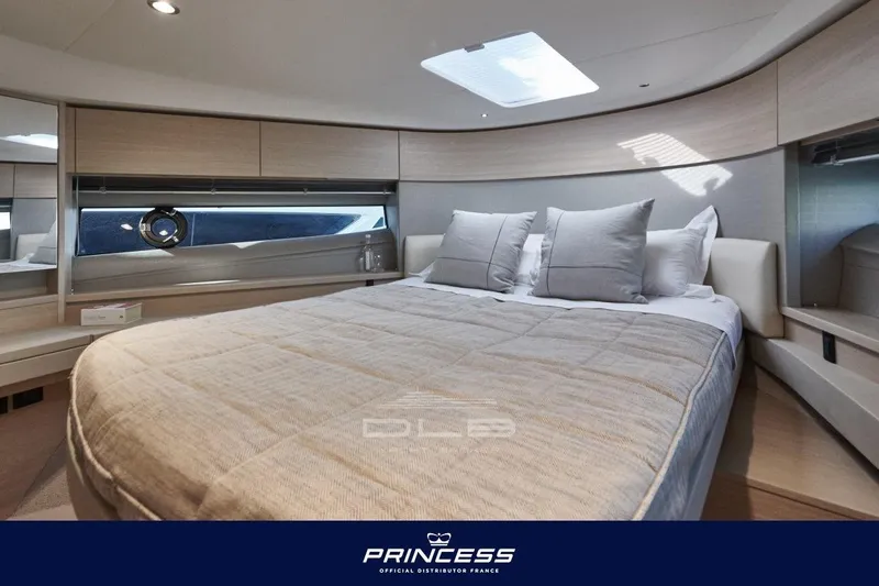  Yacht Photos Pics Luxurious interior of 2023 Princess F50 yacht with elegant bedding and modern design.