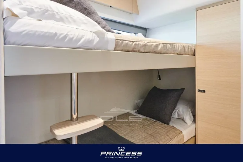  Yacht Photos Pics Bunk beds in 2023 Princess F50 yacht cabin, featuring modern design and cozy bedding.