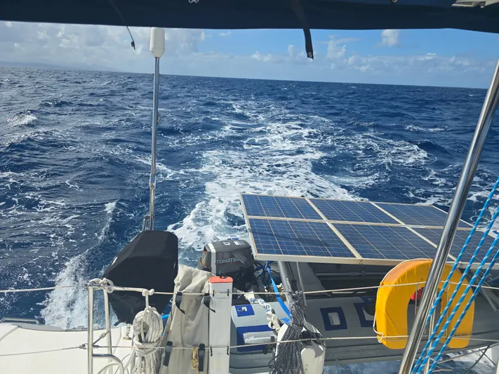 Think Twice Yacht Photos Pics Sailing on a 2005 Fountaine Pajot Lavezzi Maestro catamaran with solar panels, ocean view.