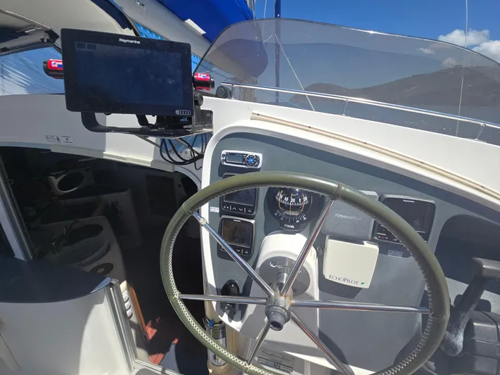 Think Twice Yacht Photos Pics 2005 Fountaine Pajot Lavezzi Maestro yacht helm with navigation equipment and steering wheel.