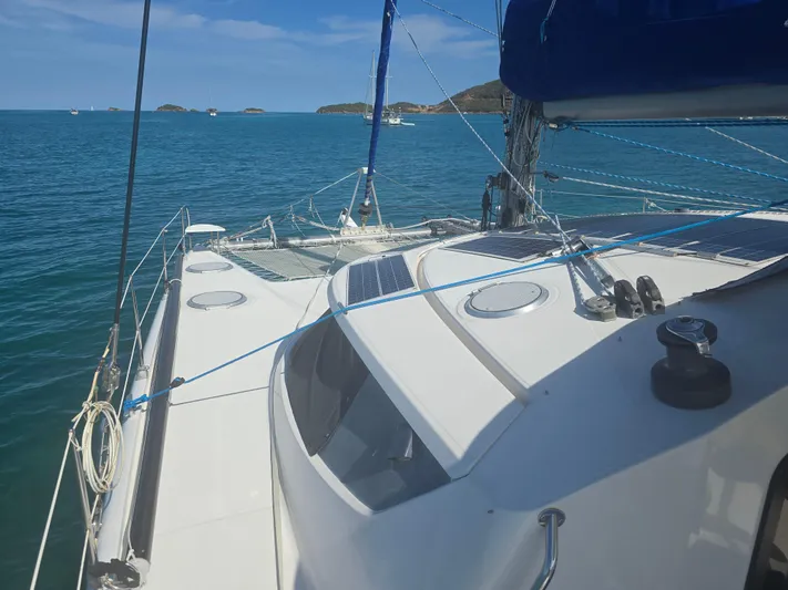 Think Twice Yacht Photos Pics 2005 Fountaine Pajot Lavezzi Maestro catamaran sailing on clear blue waters.