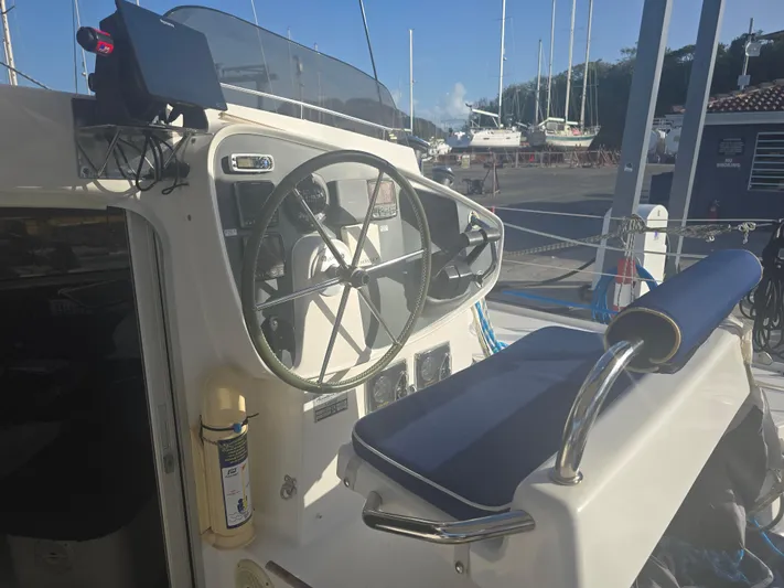 Think Twice Yacht Photos Pics Helm of 2005 Fountaine Pajot Lavezzi Maestro catamaran in marina setting.